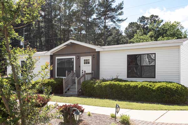 Neatly maintained mobile home with a modern exterior, showcasing potential for refinance opportunities.