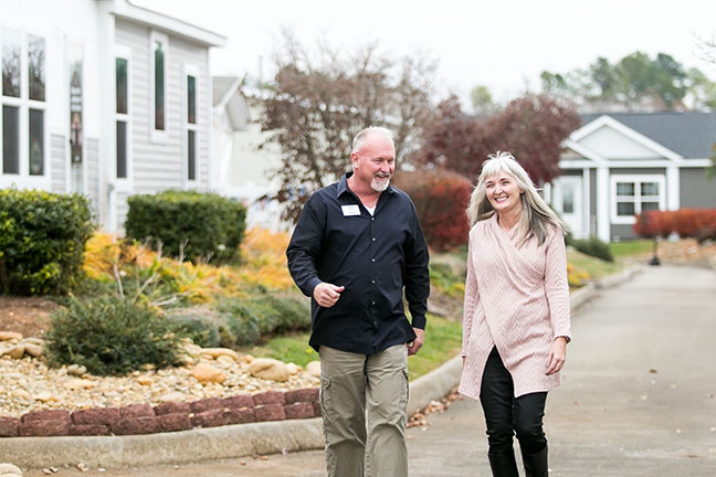 A man and woman going for a walk in their community