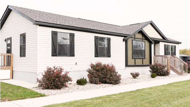 A white mobile home with black shutters