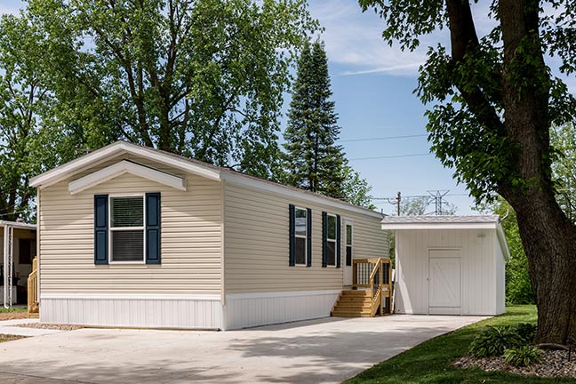 A mobile home with a separate storage unit. Many quality mobile homes like this one are available on the used market.