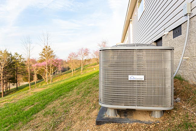 A SmartComfort air conditioning unit outside a house.