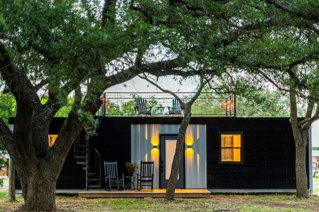 A mobile home ADU with seating on the porch and roof space.