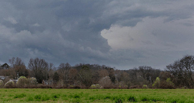 A tornado brewing near a manufactured home