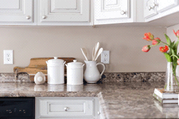 An upgraded kitchen with replacement countertops and new white cabinets