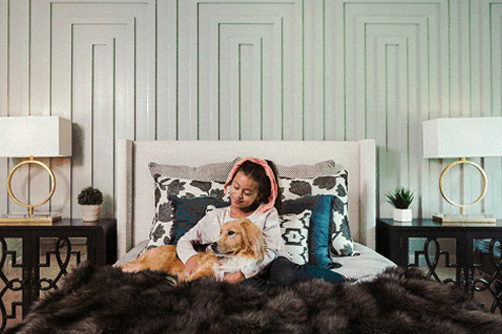 Young girl and dog, safe and warm in bed during winter months